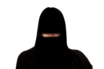 Image showing Dramatic portrait of a girl in the dark on white studio background.