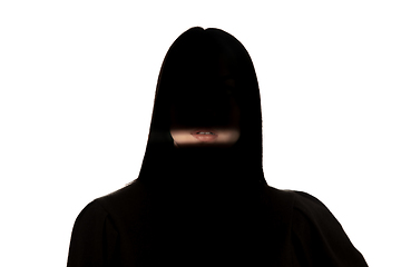 Image showing Dramatic portrait of a girl in the dark on white studio background.