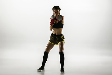 Image showing Fit caucasian woman in sportswear boxing isolated on white studio background