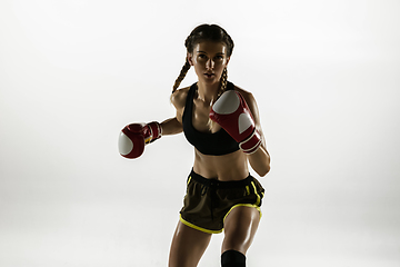 Image showing Fit caucasian woman in sportswear boxing isolated on white studio background