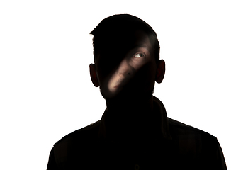 Image showing Dramatic portrait of a man in the dark on white studio background.