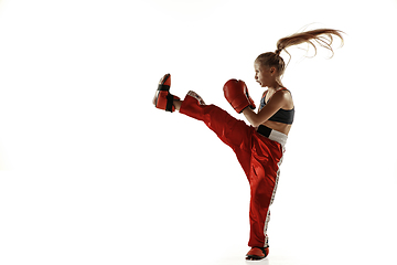 Image showing Young female kickboxing fighter training isolated on white background