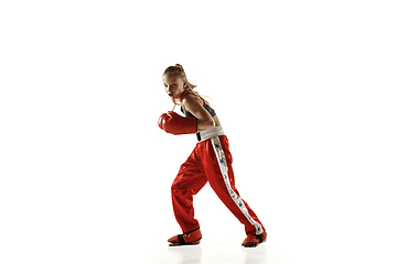 Image showing Young female kickboxing fighter training isolated on white background