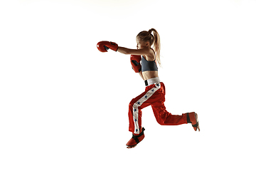 Image showing Young female kickboxing fighter training isolated on white background