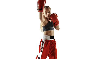 Image showing Young female kickboxing fighter training isolated on white background