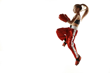 Image showing Young female kickboxing fighter training isolated on white background