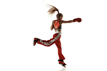 Image showing Young female kickboxing fighter training isolated on white background