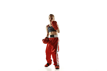 Image showing Young female kickboxing fighter training isolated on white background