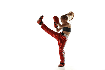 Image showing Young female kickboxing fighter training isolated on white background