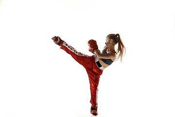 Image showing Young female kickboxing fighter training isolated on white background