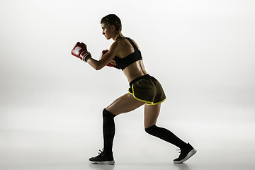 Image showing Fit caucasian woman in sportswear boxing isolated on white studio background