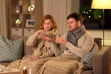 Image showing sick couple taking medicine at home