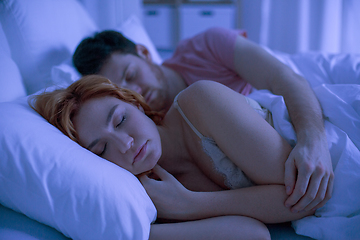 Image showing happy couple sleeping in bed at home