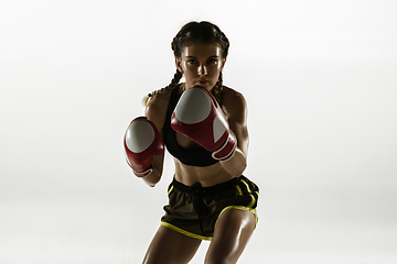 Image showing Fit caucasian woman in sportswear boxing isolated on white studio background