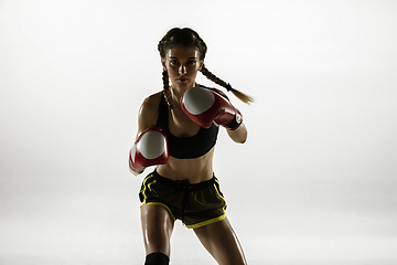 Image showing Fit caucasian woman in sportswear boxing isolated on white studio background