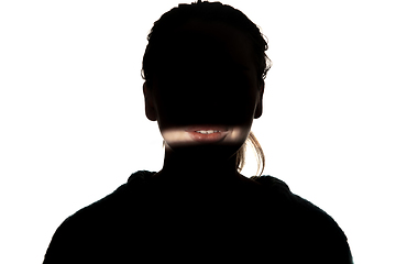 Image showing Dramatic portrait of a girl in the dark on white studio background.