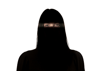 Image showing Dramatic portrait of a girl in the dark on white studio background.