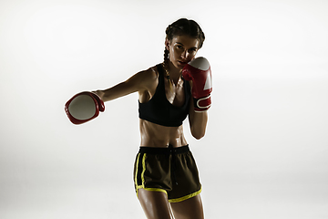 Image showing Fit caucasian woman in sportswear boxing isolated on white studio background