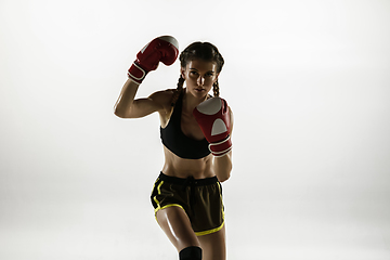 Image showing Fit caucasian woman in sportswear boxing isolated on white studio background