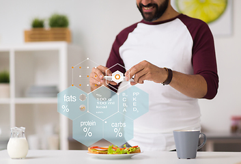 Image showing man with phone and food nutritional value chart