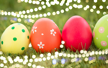 Image showing row of colored easter eggs on artificial grass