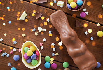 Image showing chocolate eggs, easter bunny and candies on wood