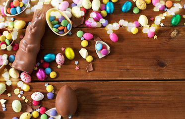 Image showing chocolate eggs, easter bunny and candies on wood