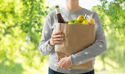 Image showing close up of woman with paper bag full of food