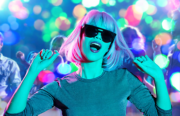 Image showing woman in wig and sunglasses dancing at nightclub