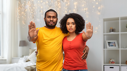 Image showing african american couple showing stop gesture