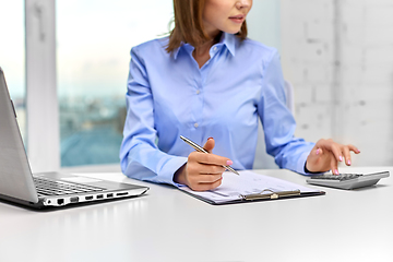 Image showing businesswoman with papers, laptop and calculator