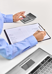 Image showing businesswoman with papers, laptop and calculator