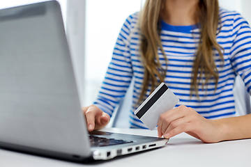 Image showing teenage girl with laptop and credit card at home