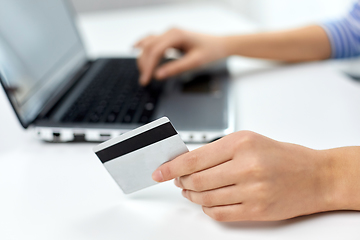 Image showing teenage girl with laptop and credit card at home