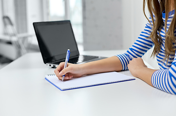 Image showing student girl with exercise book, pen and laptop