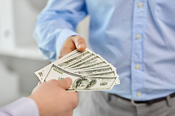 Image showing close up of businessmen's hands holding money
