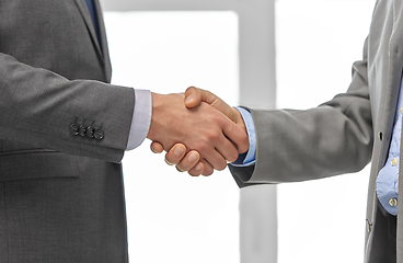 Image showing close up of businessmen making handshake at office