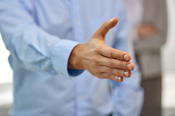 Image showing businessman making handshake at office