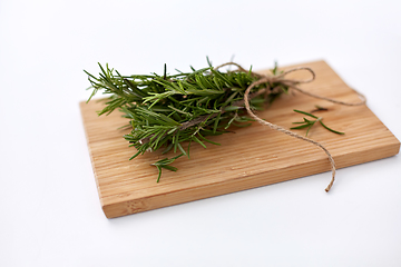 Image showing bunch of rosemary on wooden cutting board
