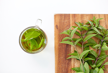 Image showing herbal tea with fresh peppermint on wooden board