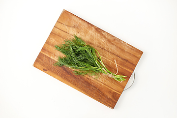 Image showing bunch of dill on wooden cutting board