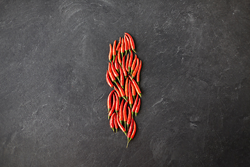 Image showing red chili or cayenne pepper on slate stone surface