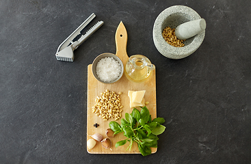 Image showing ingredients for basil pesto sauce on wooden board