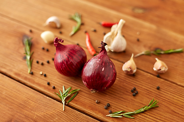 Image showing onion, garlic, chili pepper and rosemary on table