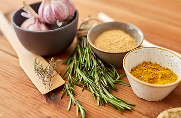 Image showing spices, rosemary, wooden spatula and garlic