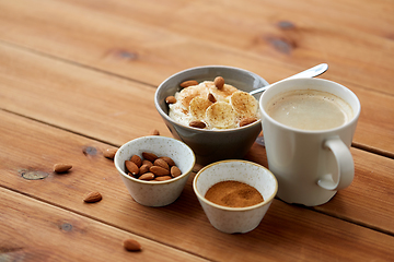 Image showing oatmeal with banana and almond on wooden table