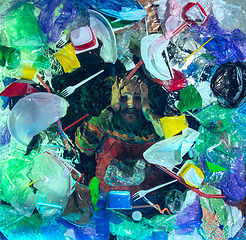 Image showing Man drowning in ocean water under plastic recipients pile, environment concept