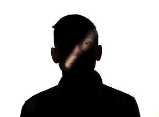 Image showing Dramatic portrait of a man in the dark on white studio background.