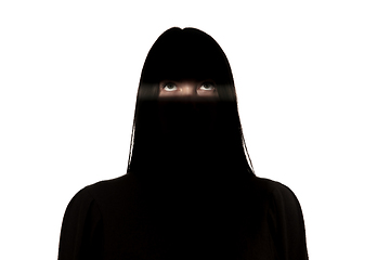 Image showing Dramatic portrait of a girl in the dark on white studio background.