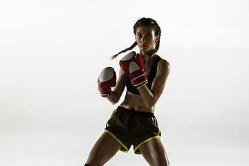 Image showing Fit caucasian woman in sportswear boxing isolated on white studio background